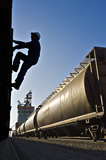 A worker inspects a rail hopper car at an inland grain terminal