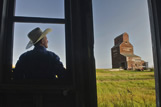 Older man, abandoned grain elevator, ghost town of Bents